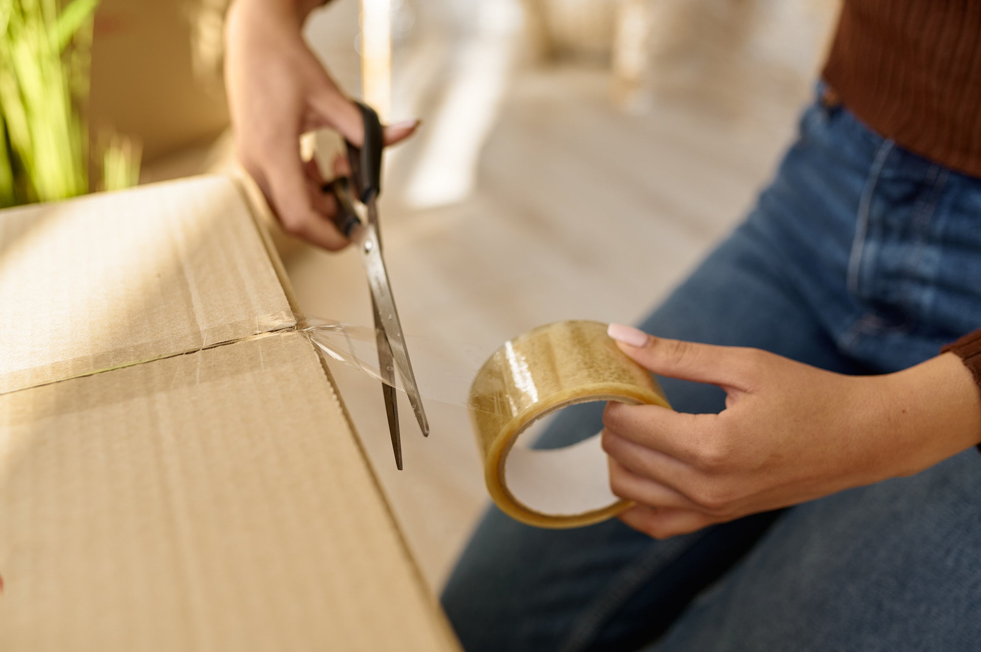 Closeup view on female hand packing box